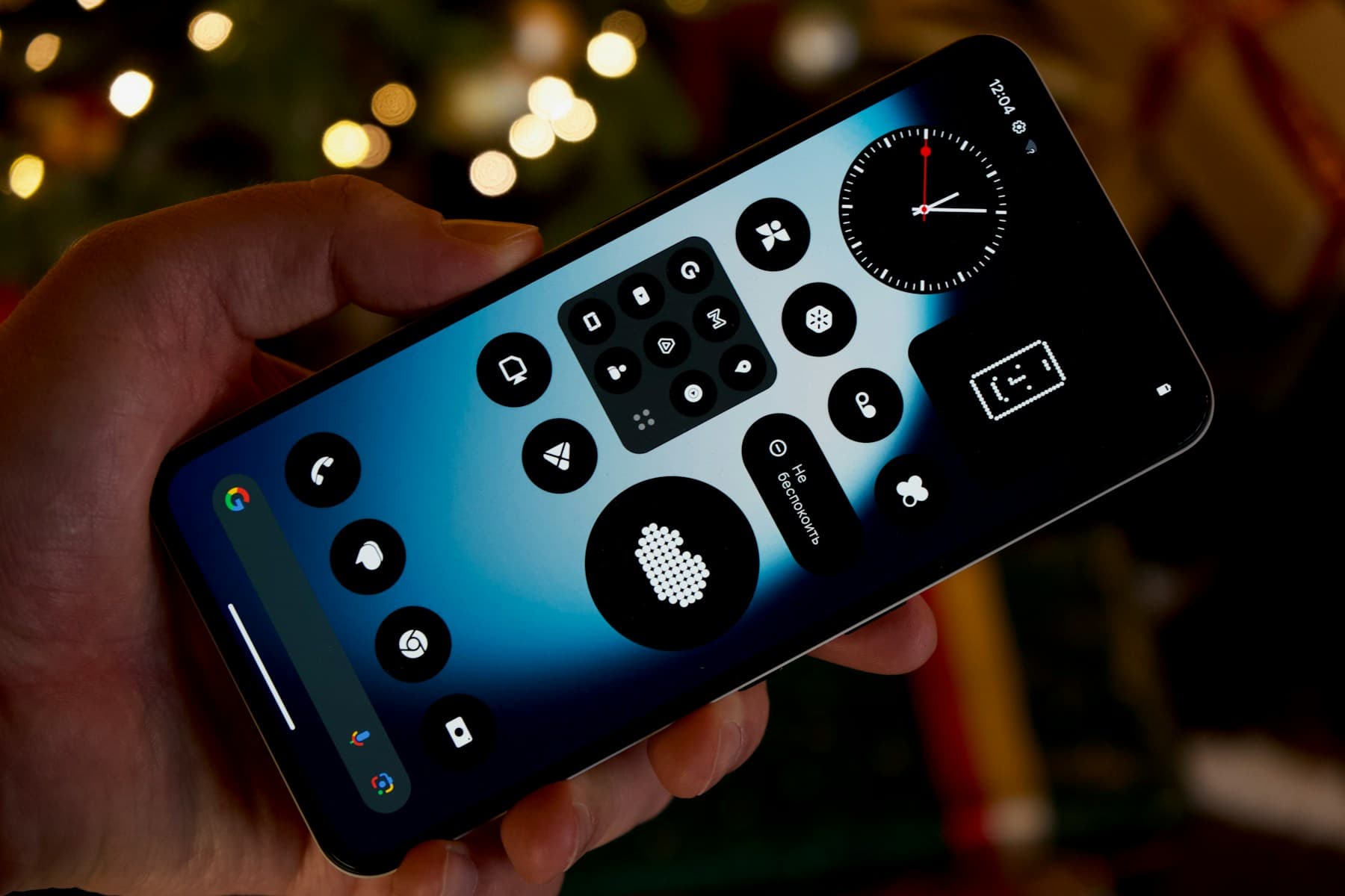 Hand holding a smartphone displaying a bright abstract interface.